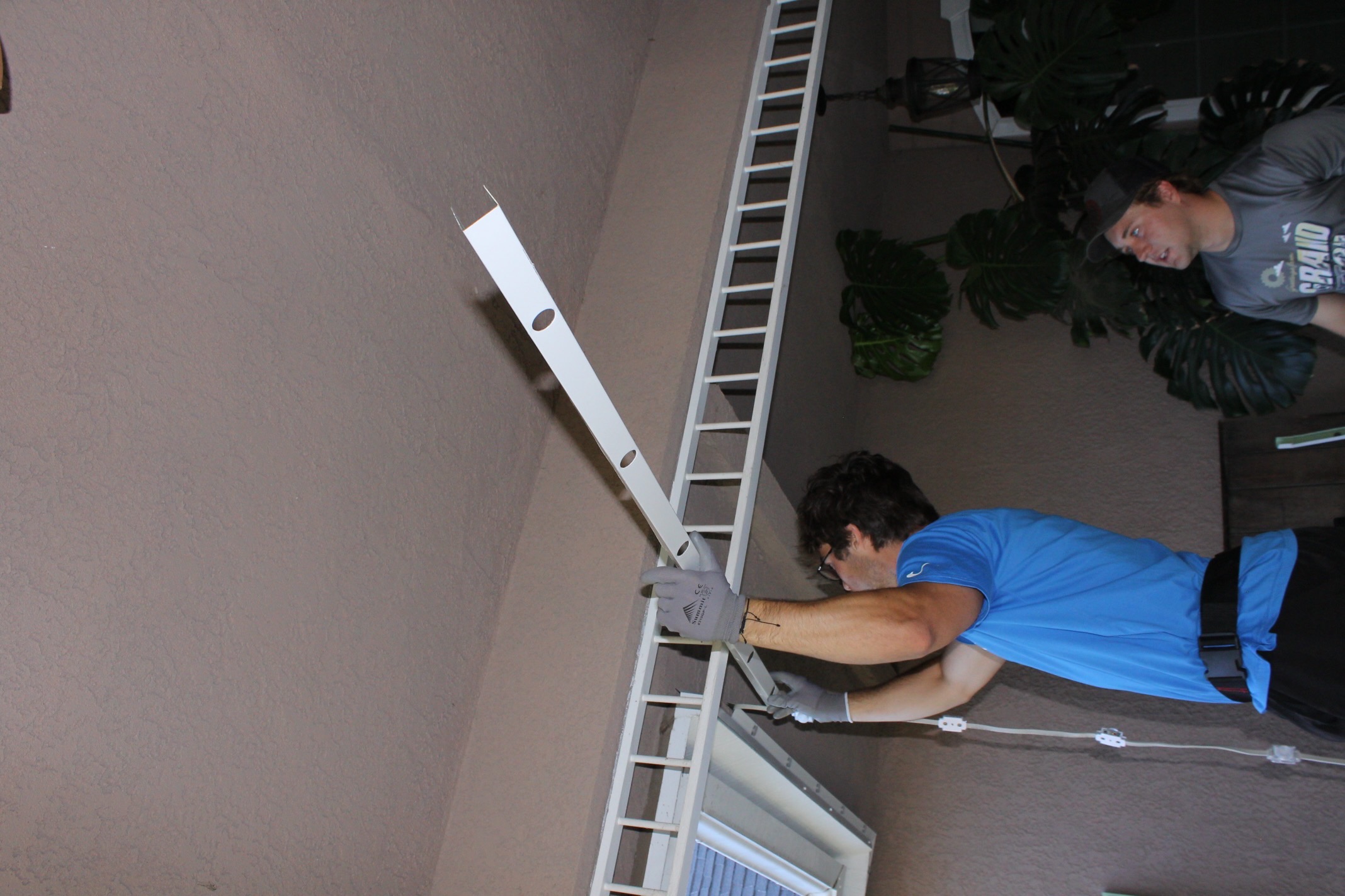 Halo crew installing a permanent roofline lighting channel