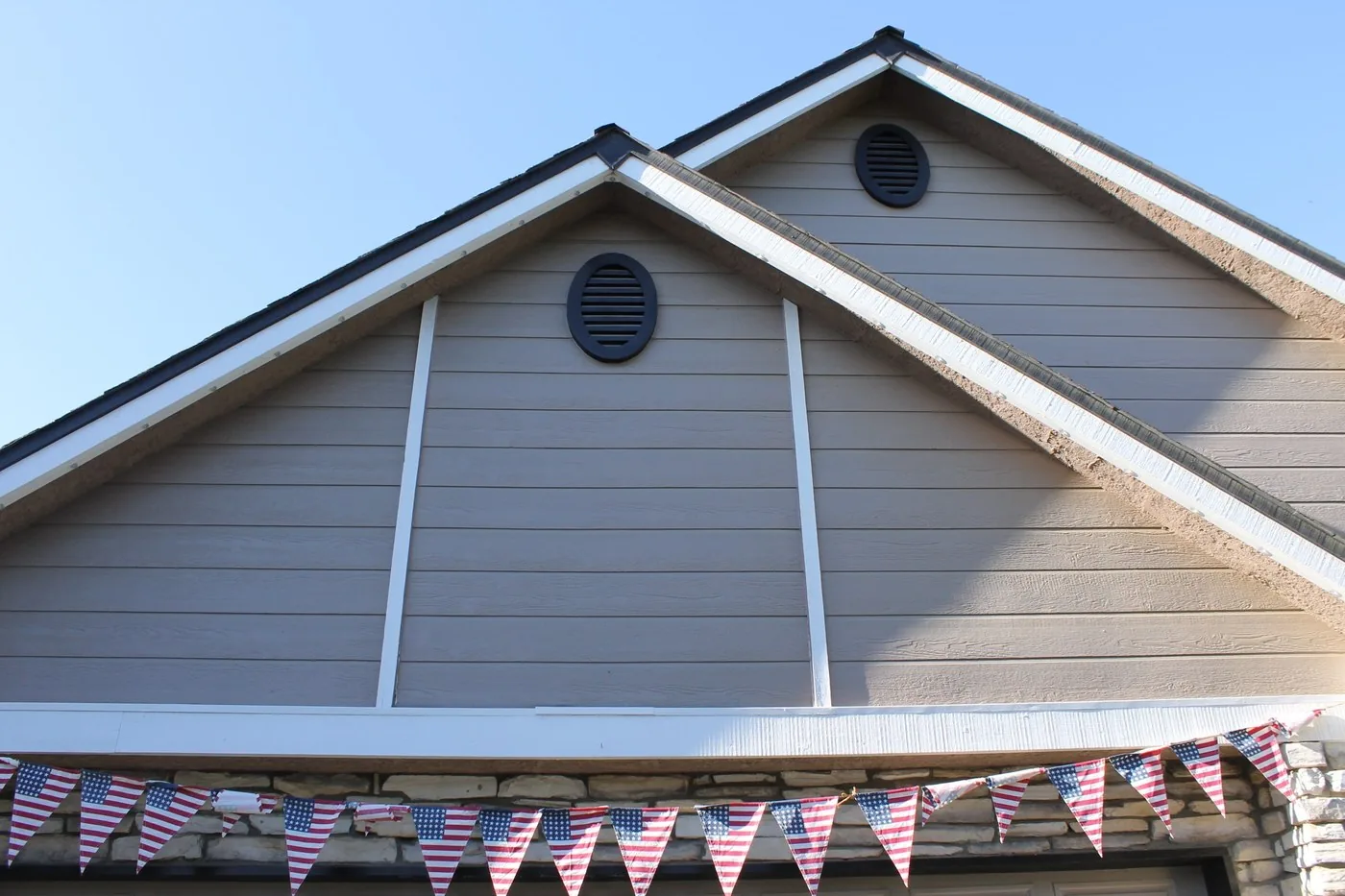 Roofline in daylight with the permanent lighting channel mounted flush under the roof edge, barely visible